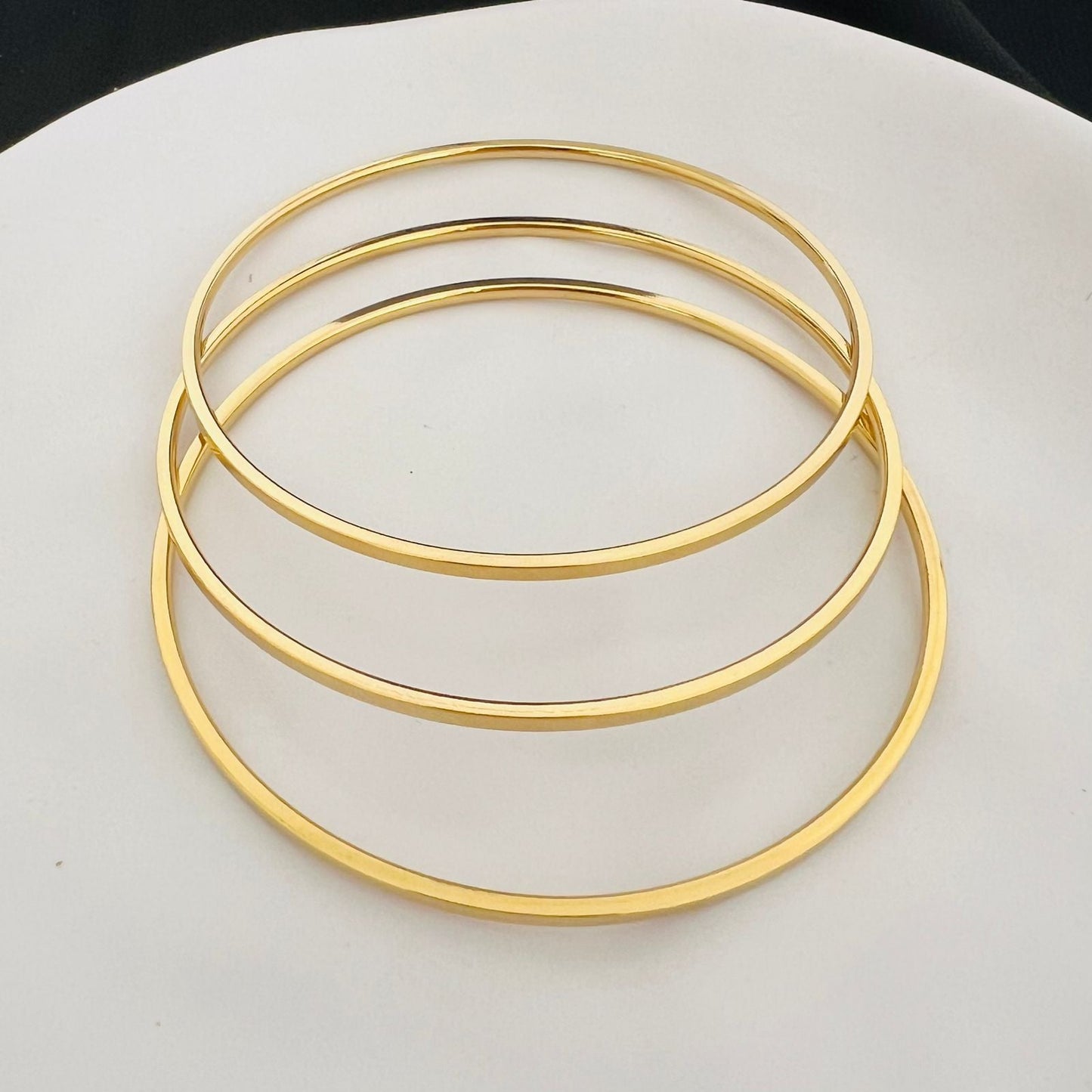 Stainless steel- 3 thin gold bangles two sizes